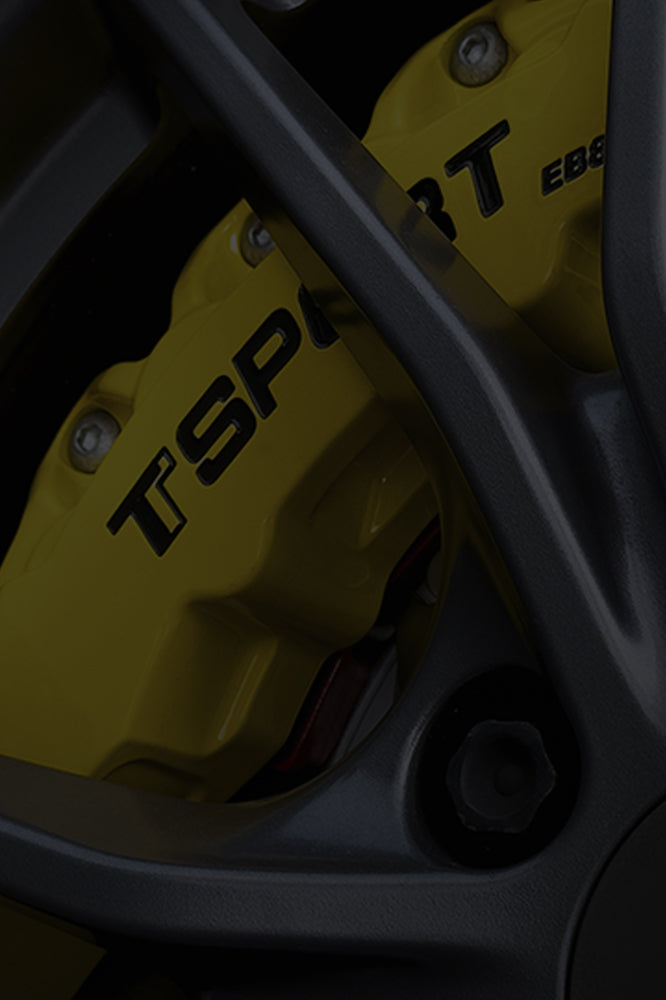 A yellow TTSPORT Evolution Series 8-piston big brake kit.