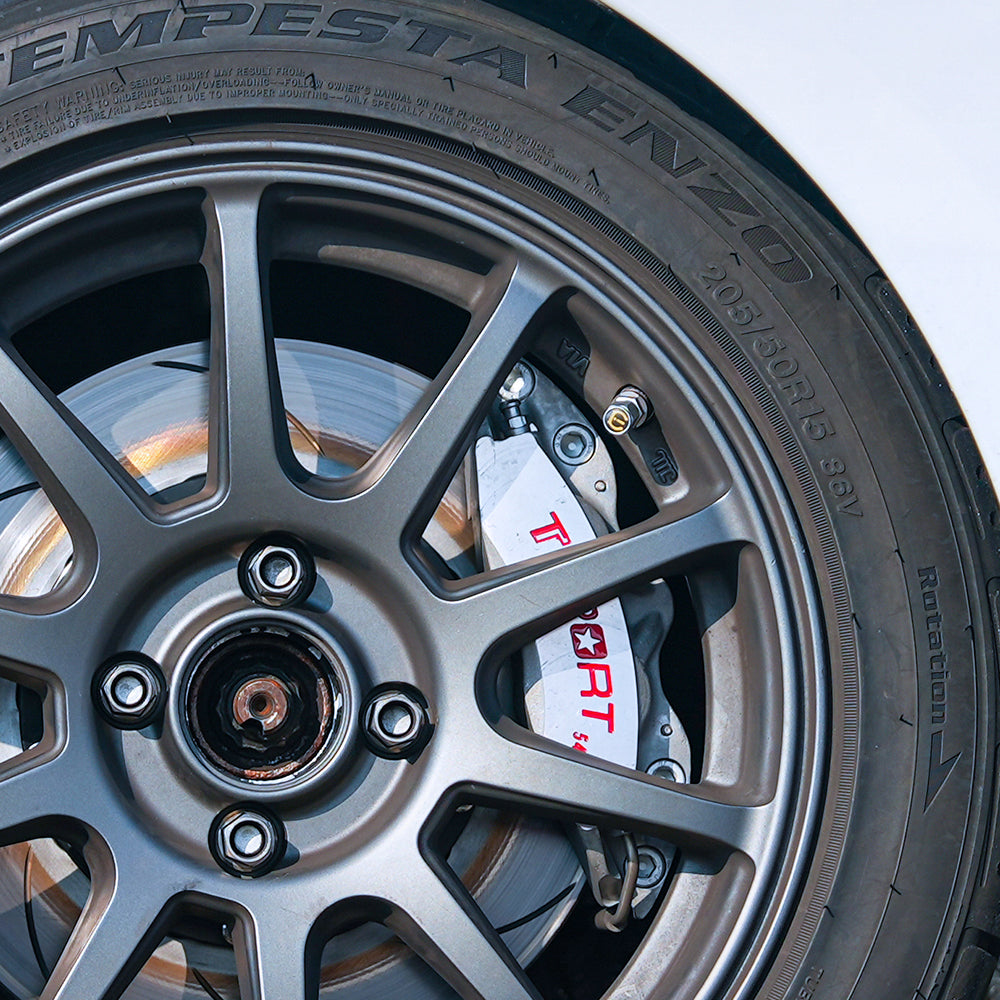 A red TTSPORT 5420S 4-piston big brake kit is installed on the 15" front wheel.