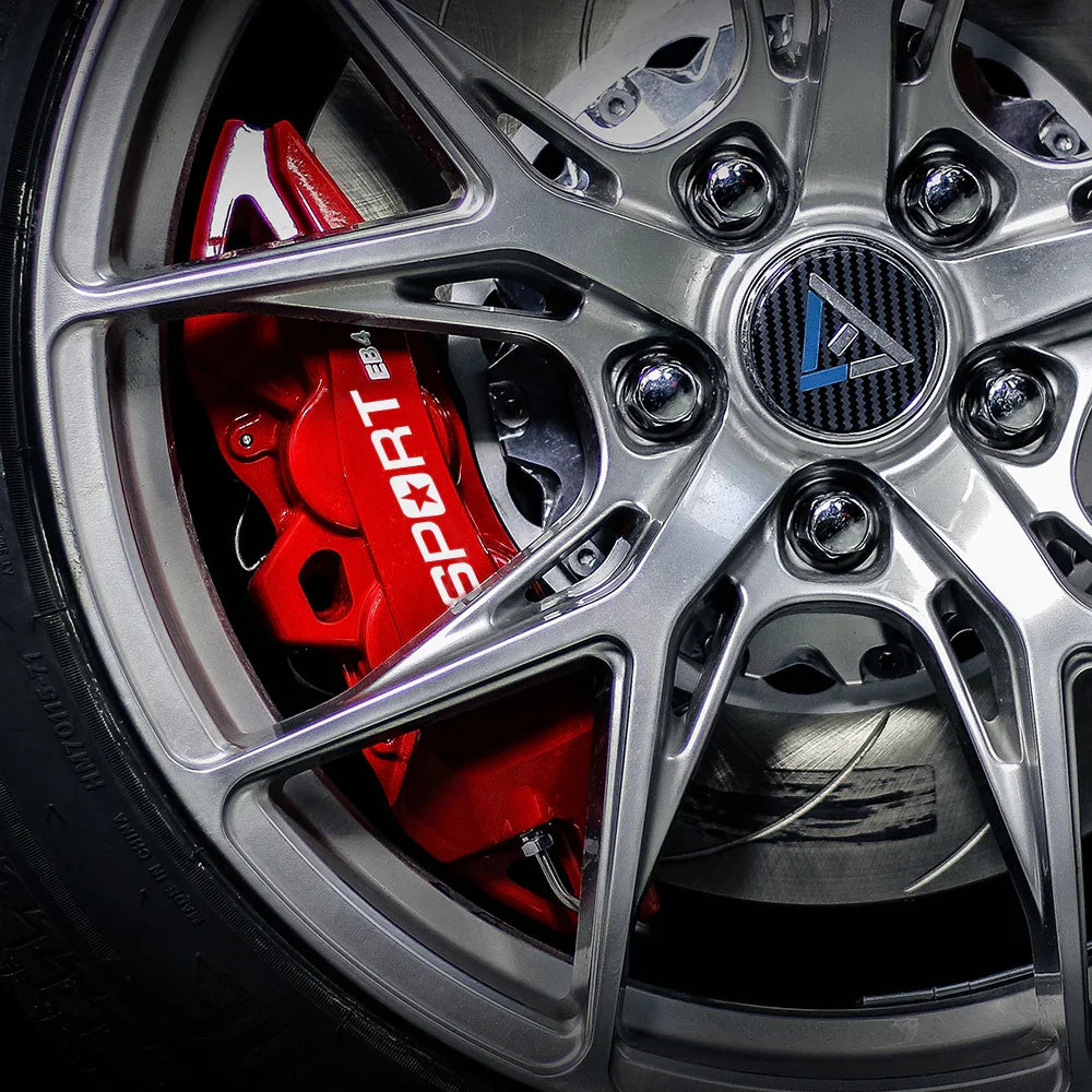 A red TTSPORT EB4 4-piston big brake kit is installed on the 18" front wheel.