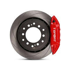 Close-up of a red TTSPORT Toyota Land Cruiser and Prado 4-piston forged brake caliper for the rear wheel and a slotted 2-piece rotor.