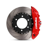 Close-up of a red TTSPORT Toyota Land Cruiser 200 6-piston forged brake caliper for the front wheel and a slotted 2-piece rotor.